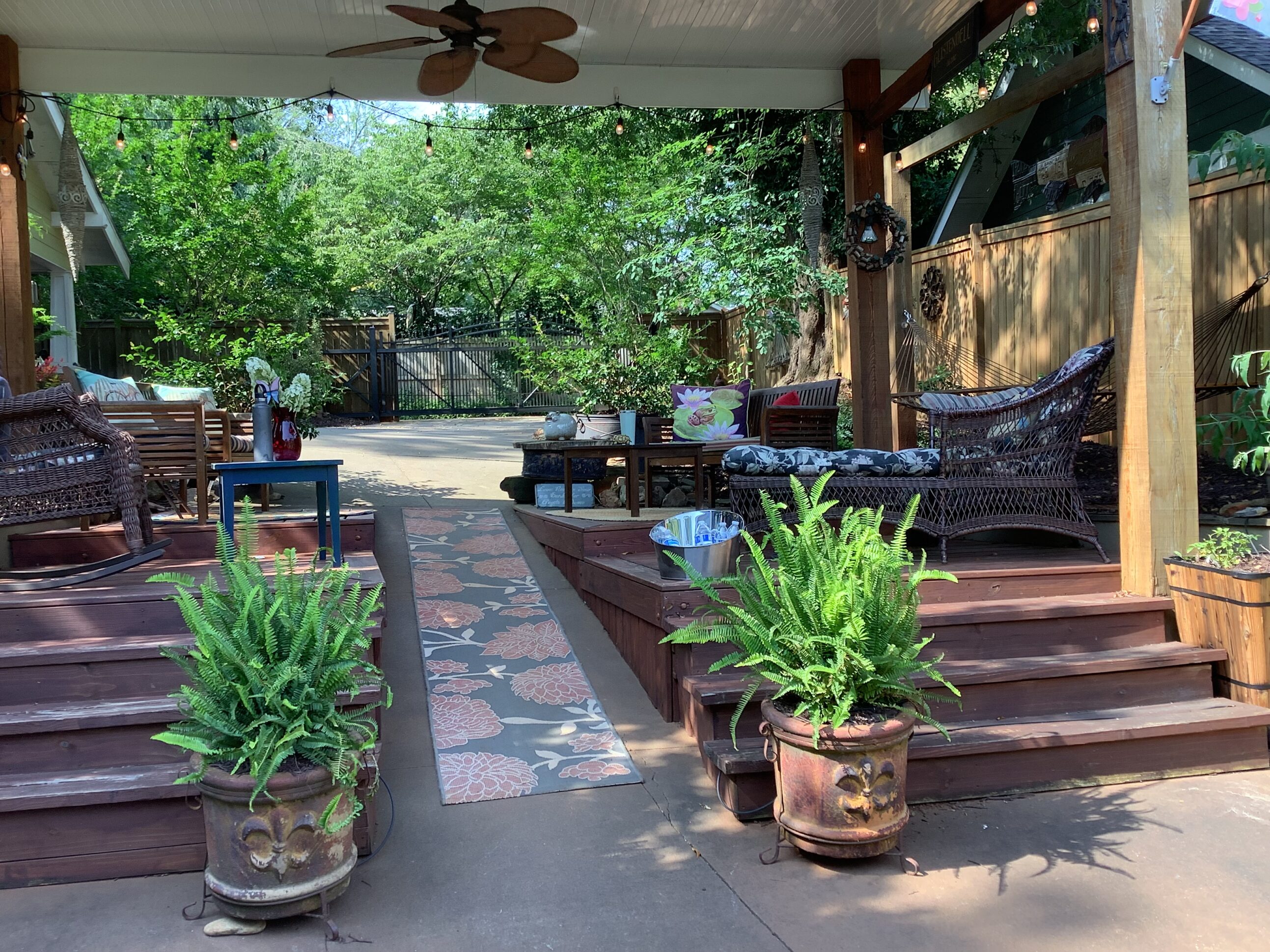 A patio with several potted plants and a gazebo.