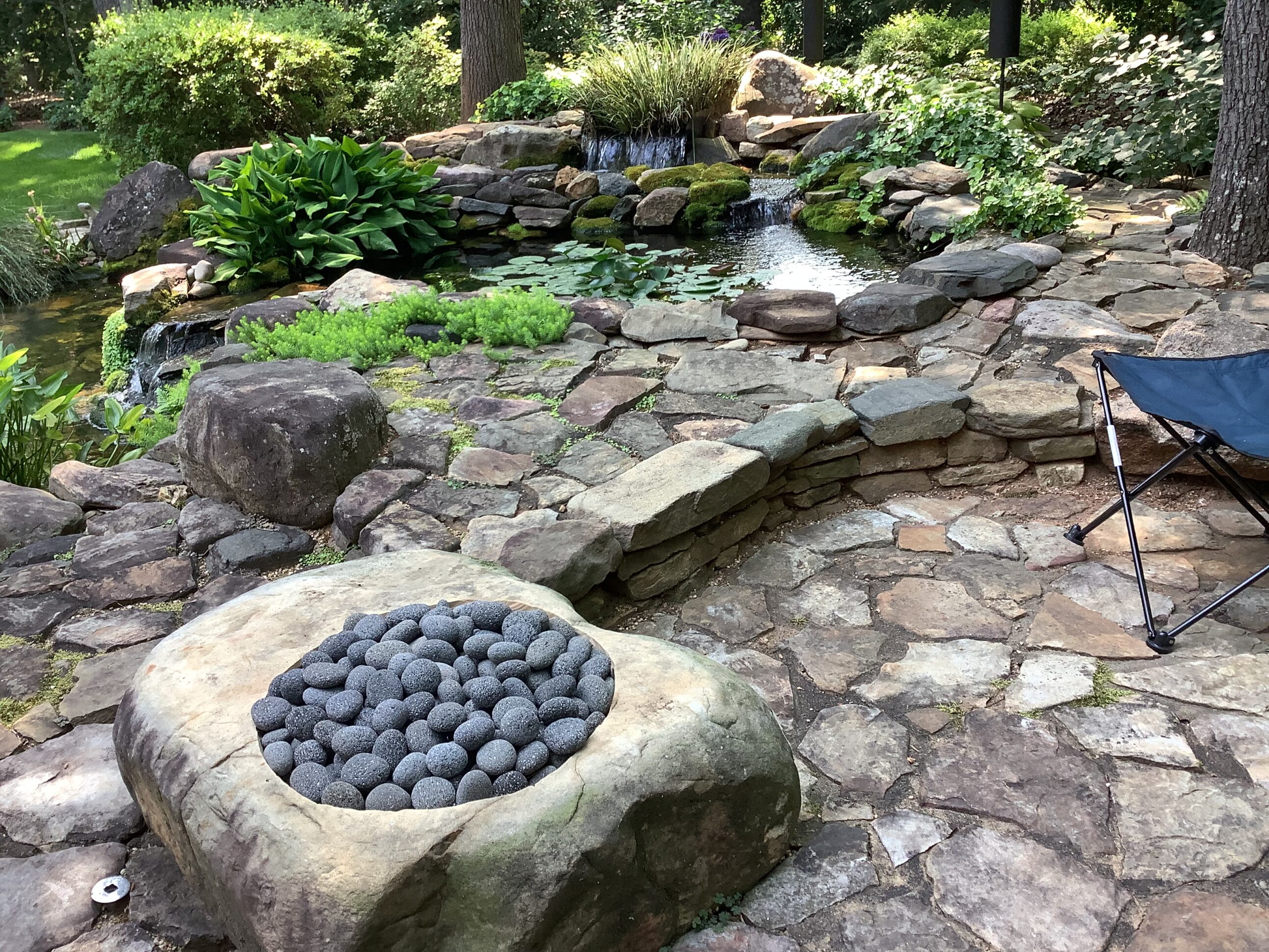 A stone garden with rocks and water features.